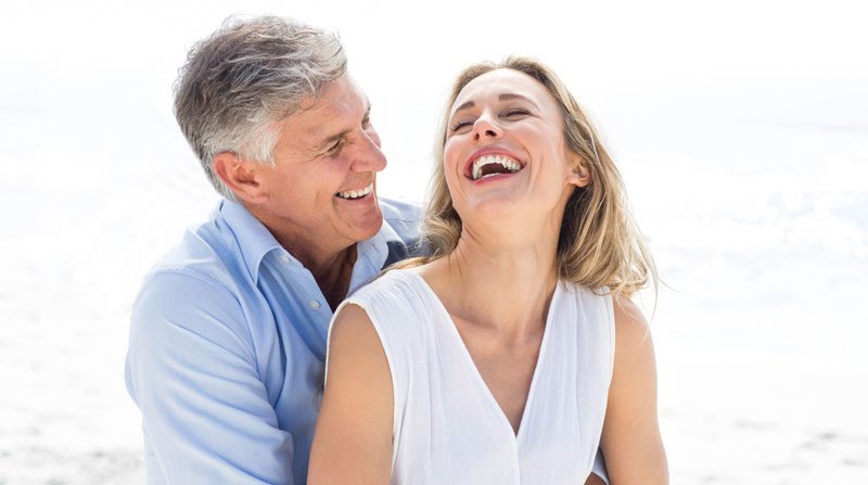 Aged Couple Smiling with Dental Bridge