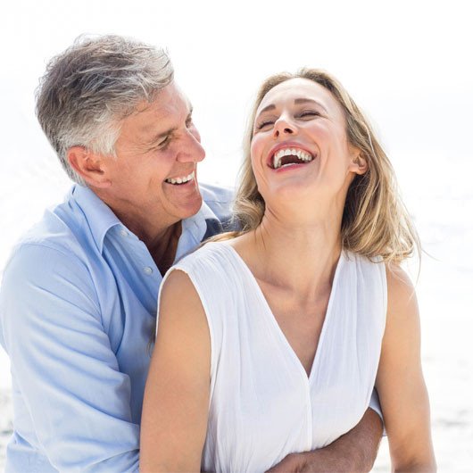 Couple Smiling with Dental Implants